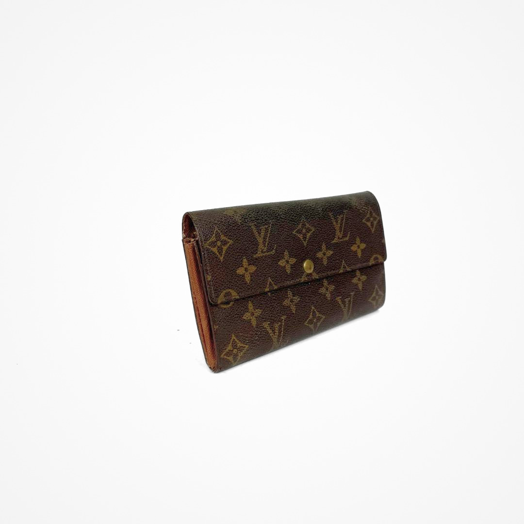 Louis Vuitton Wallet Large with gold monogram pattern on a white background