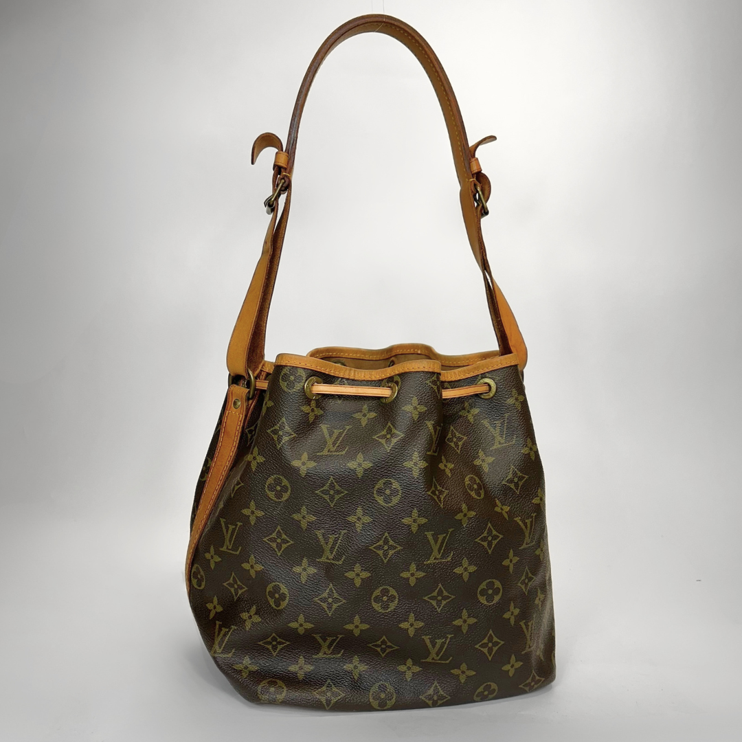 Designer handbag with monogram pattern on a light gray background