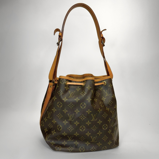 Designer handbag with monogram pattern on a light gray background