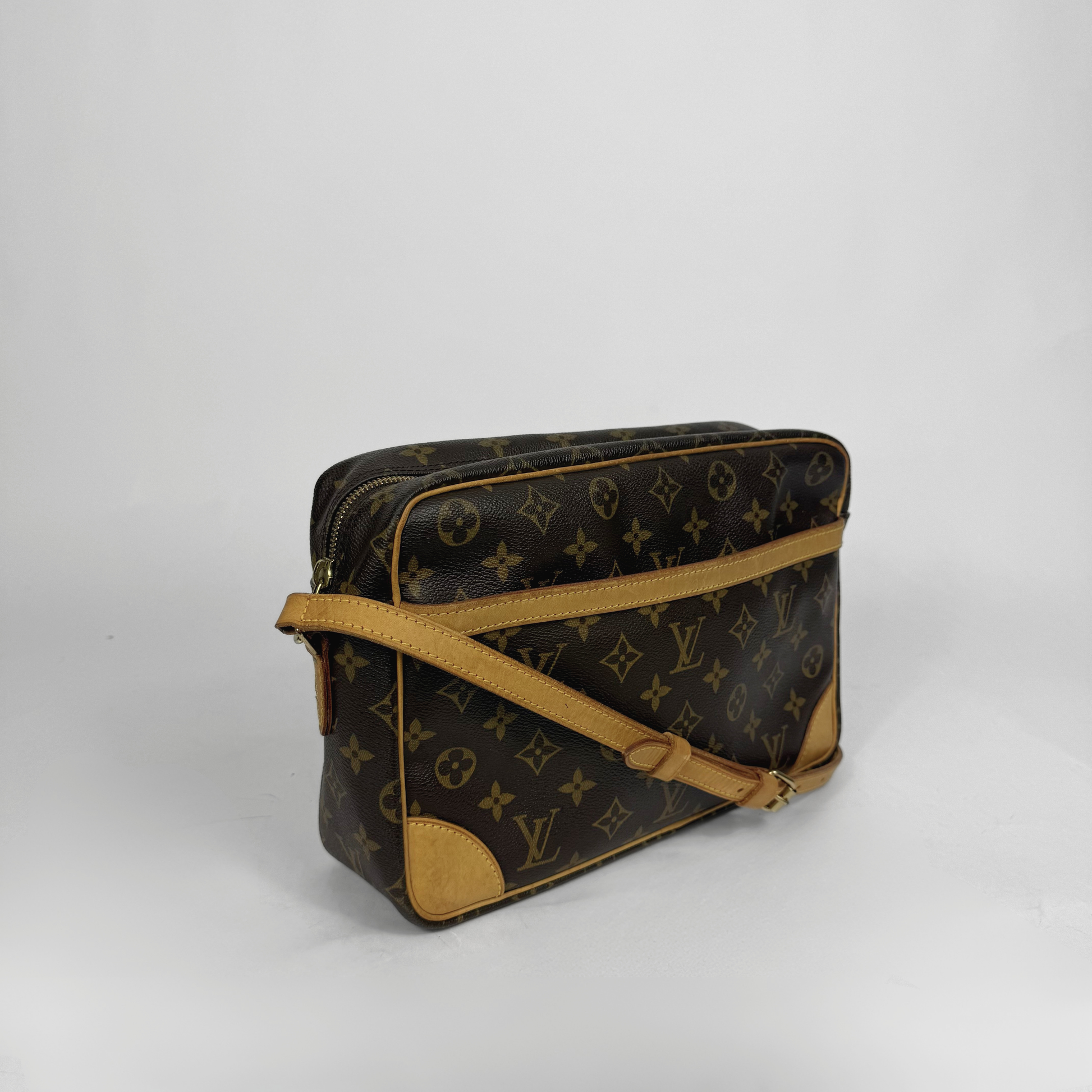 Designer handbag with monogram pattern on a white background