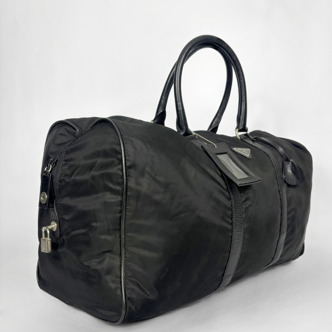 Black backpack with a strap and lock on a white background