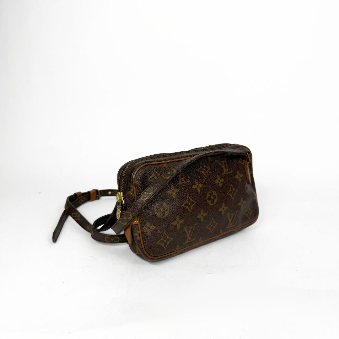 Brown leather bag with monogram pattern on a white background