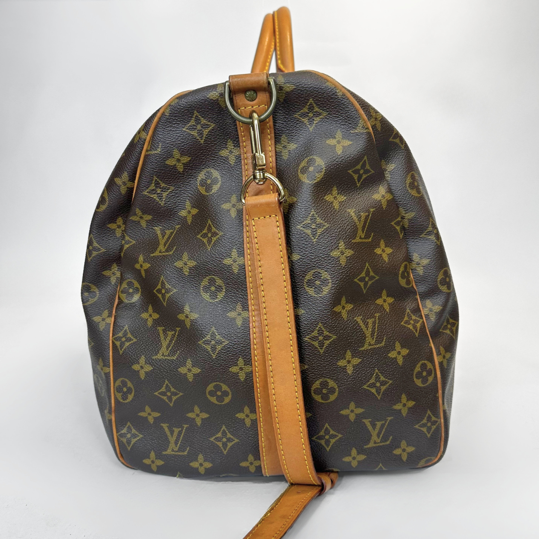Brown backpack with tan leather straps on a white background