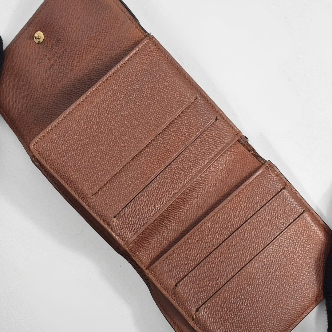 Brown leather wallet with multiple card slots on a white background