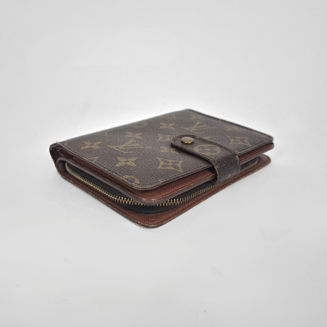 Brown wallet with monogram pattern on a light gray background
