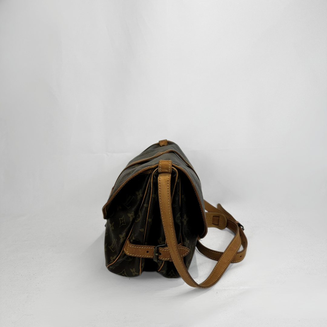 A Louis Vuitton shoulder bag in dark brown monogram canvas with tan leather trim and strap, shown from a side angle on a white studio background.