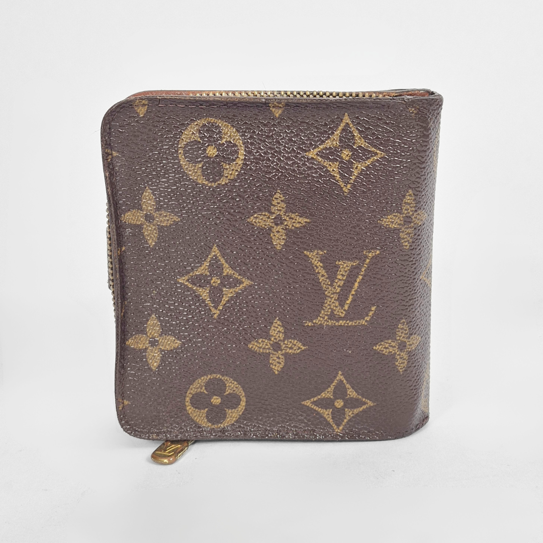 Louis Vuitton wallet with monogram pattern on a white background