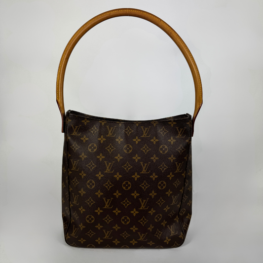 A Louis Vuitton monogram canvas shoulder bag with a brown leather handle, photographed against a neutral light gray background.