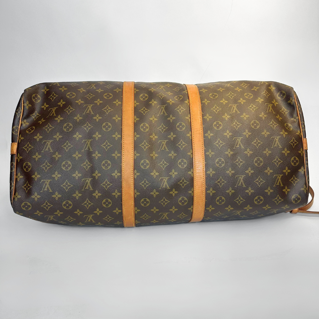 Brown travel bag with monogram pattern on a white background
