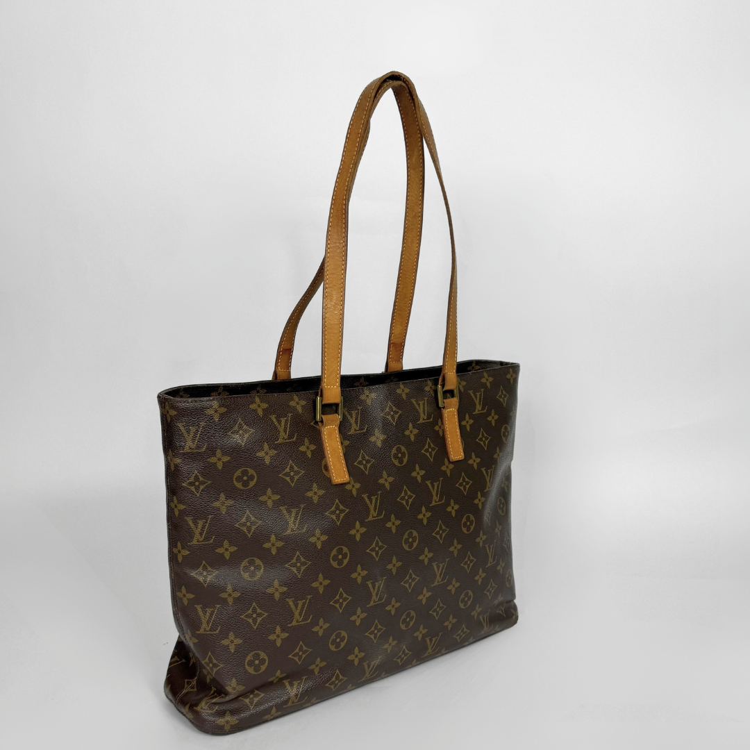 Brown leather handbag with tan handles on a white background