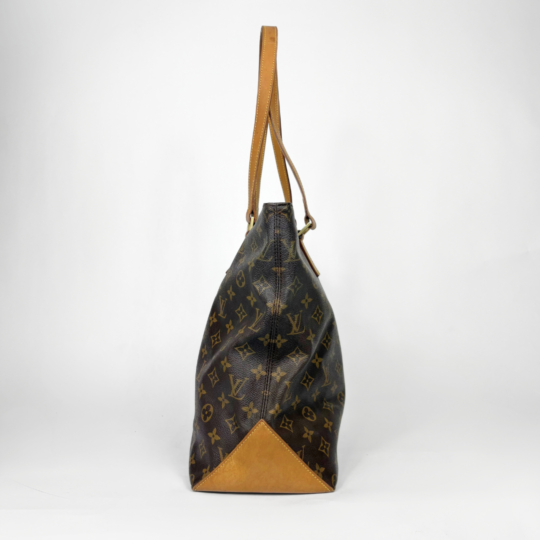 Designer handbag with monogram pattern on a white background