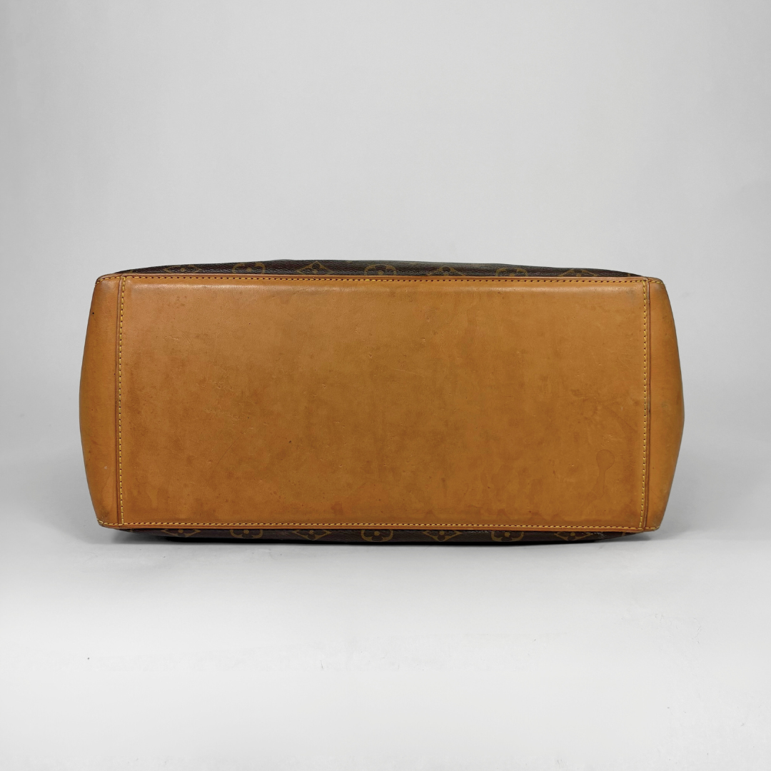 Brown leather bag on a gray background
