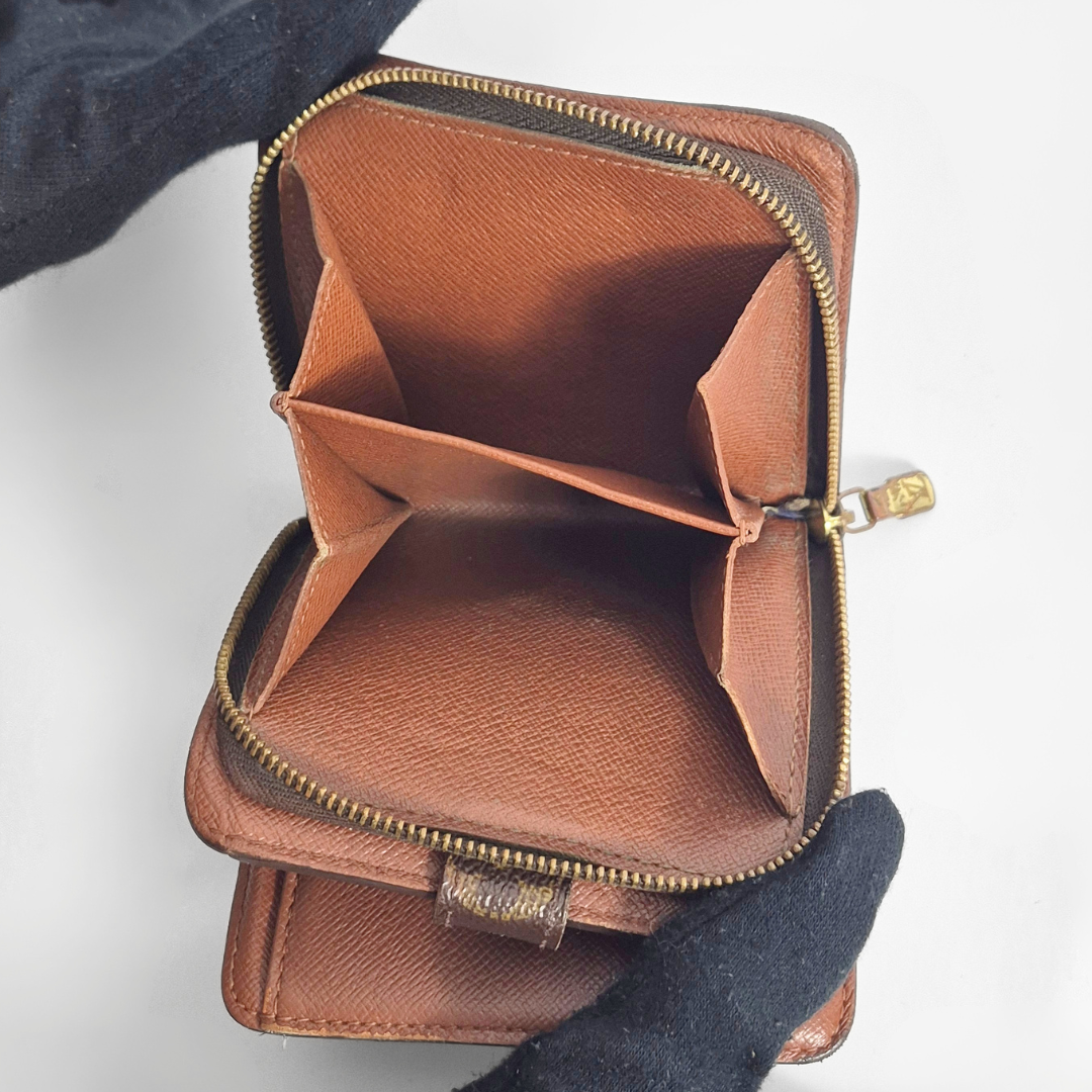 Brown leather wallet with gold zipper on a white background