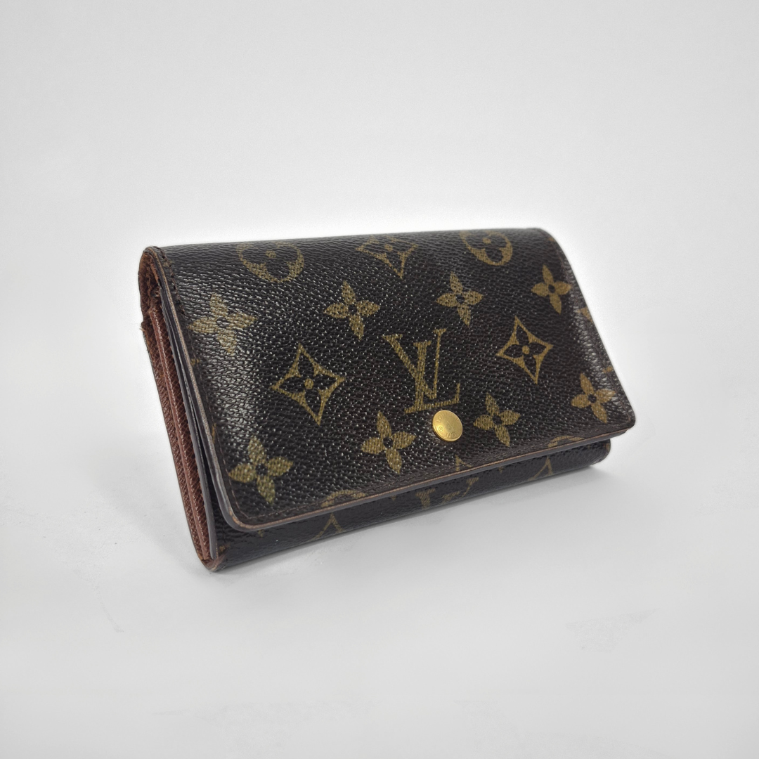 Louis Vuitton wallet with monogram pattern on a white background