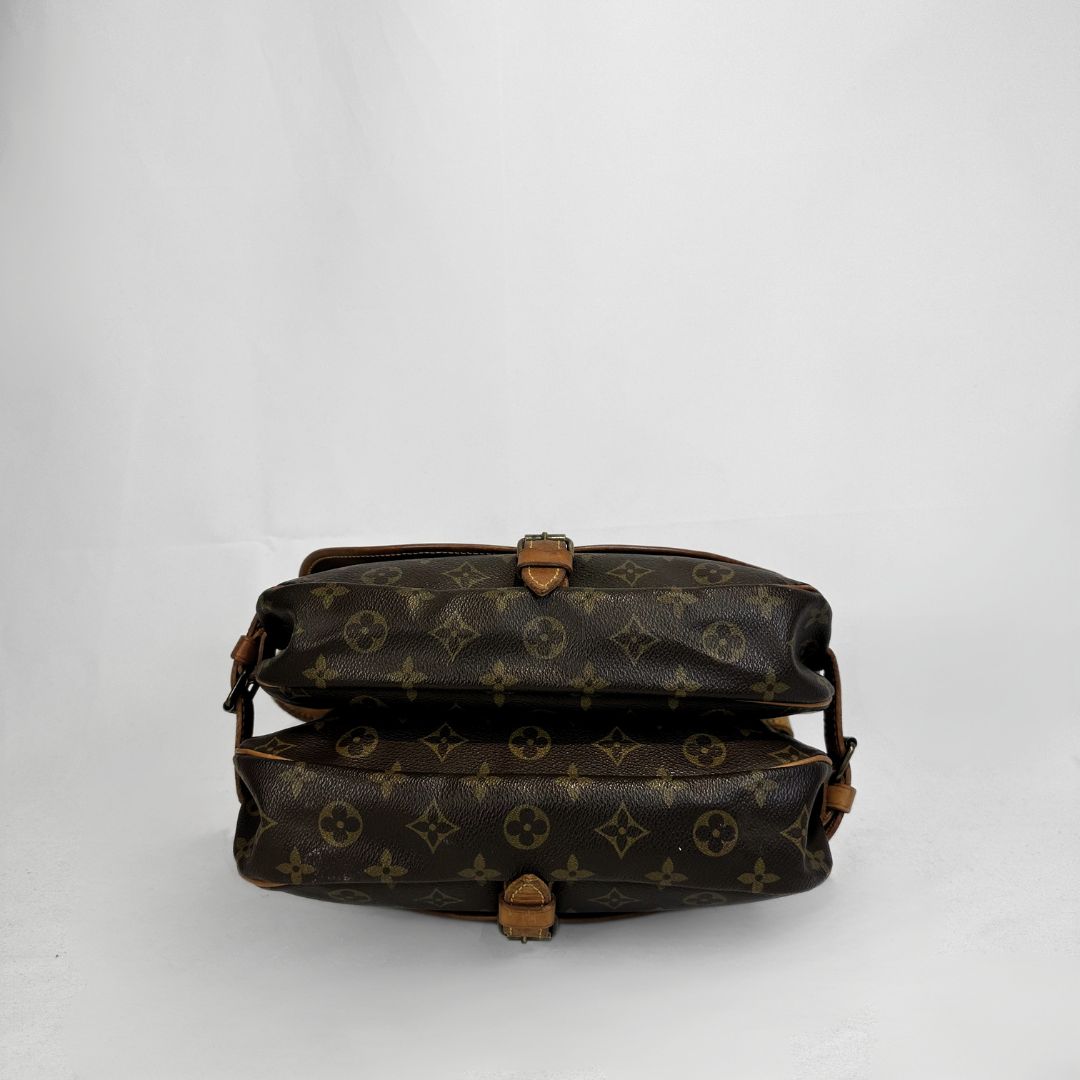 A vintage Louis Vuitton monogram shoulder bag in brown coated canvas with tan leather trim and hardware, shown from the back against a light gray background.