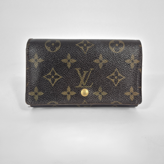 Louis Vuitton wallet with monogram pattern on a light gray background