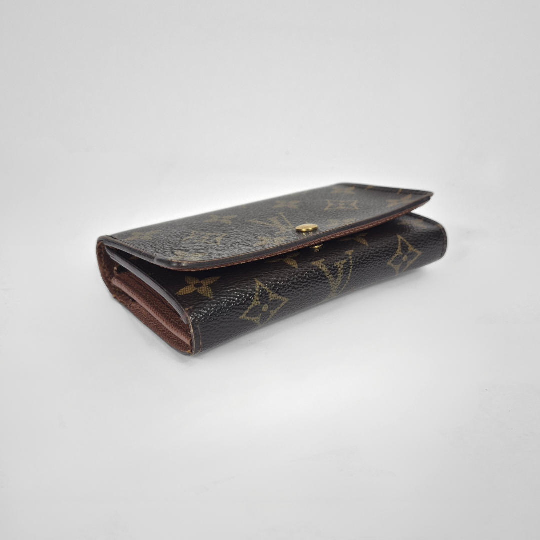 Vintage Louis Vuitton wallet with monogram pattern on a white background