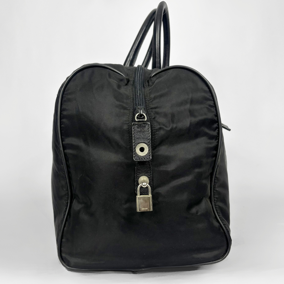Black backpack with a strap and lock on a white background