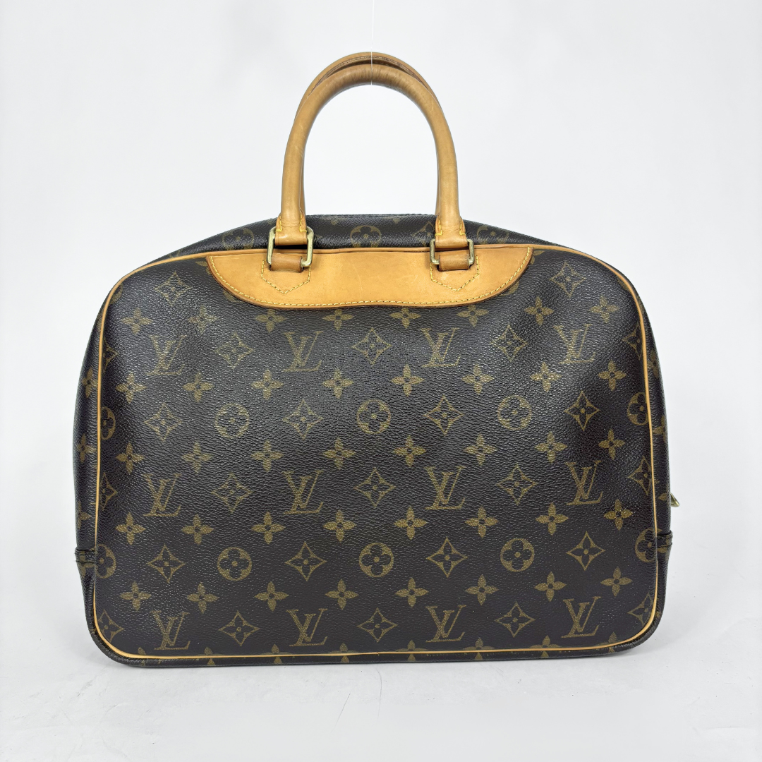 Designer handbag with monogram pattern on a white background
