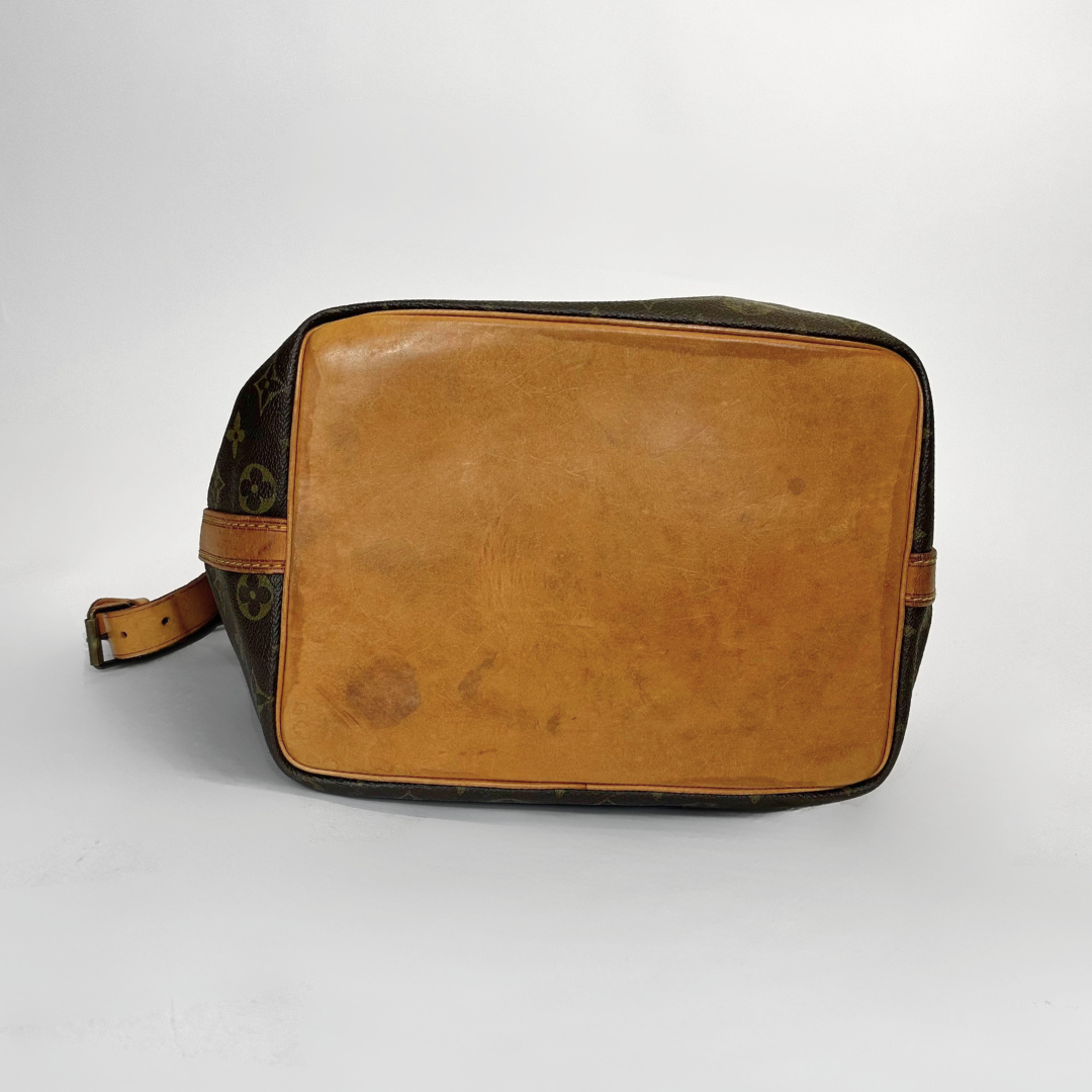 Brown leather duffel bag with visible wear on a white background