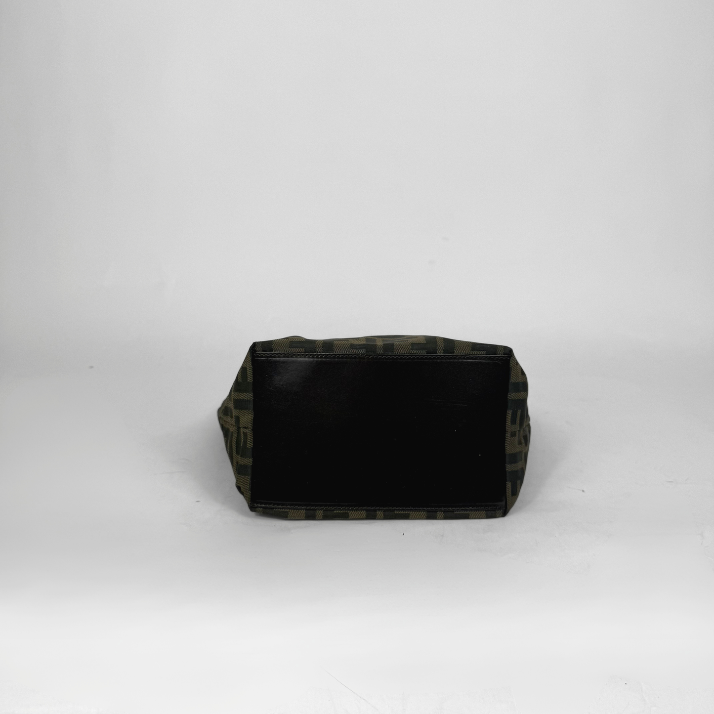 Black rectangular object with camouflage pattern on a white background