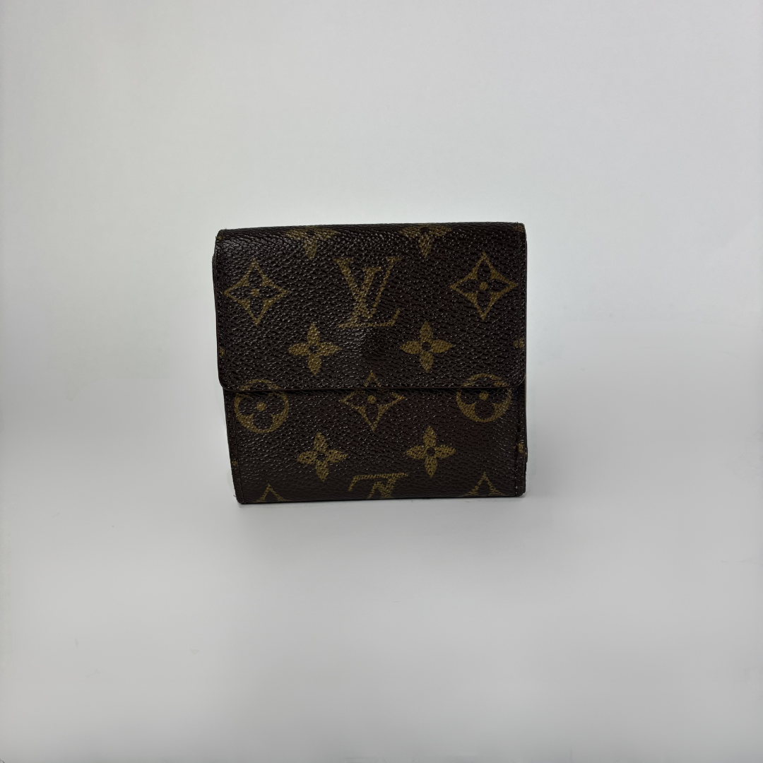 A Louis Vuitton monogram wallet in dark brown coated canvas with tan/gold printed monogram motifs, shown against a plain light gray background.