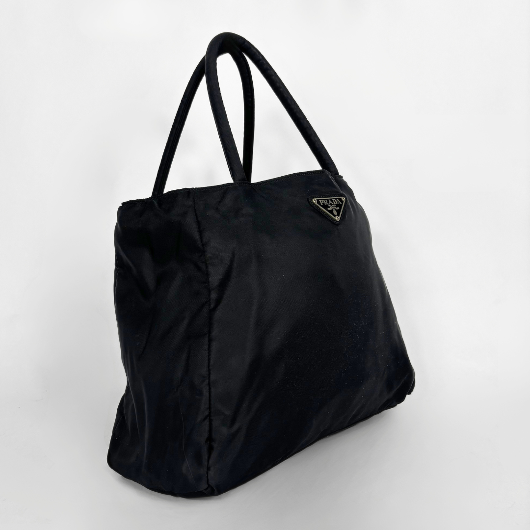 Prada black nylon tote bag with top handles and the classic enamel triangle logo.