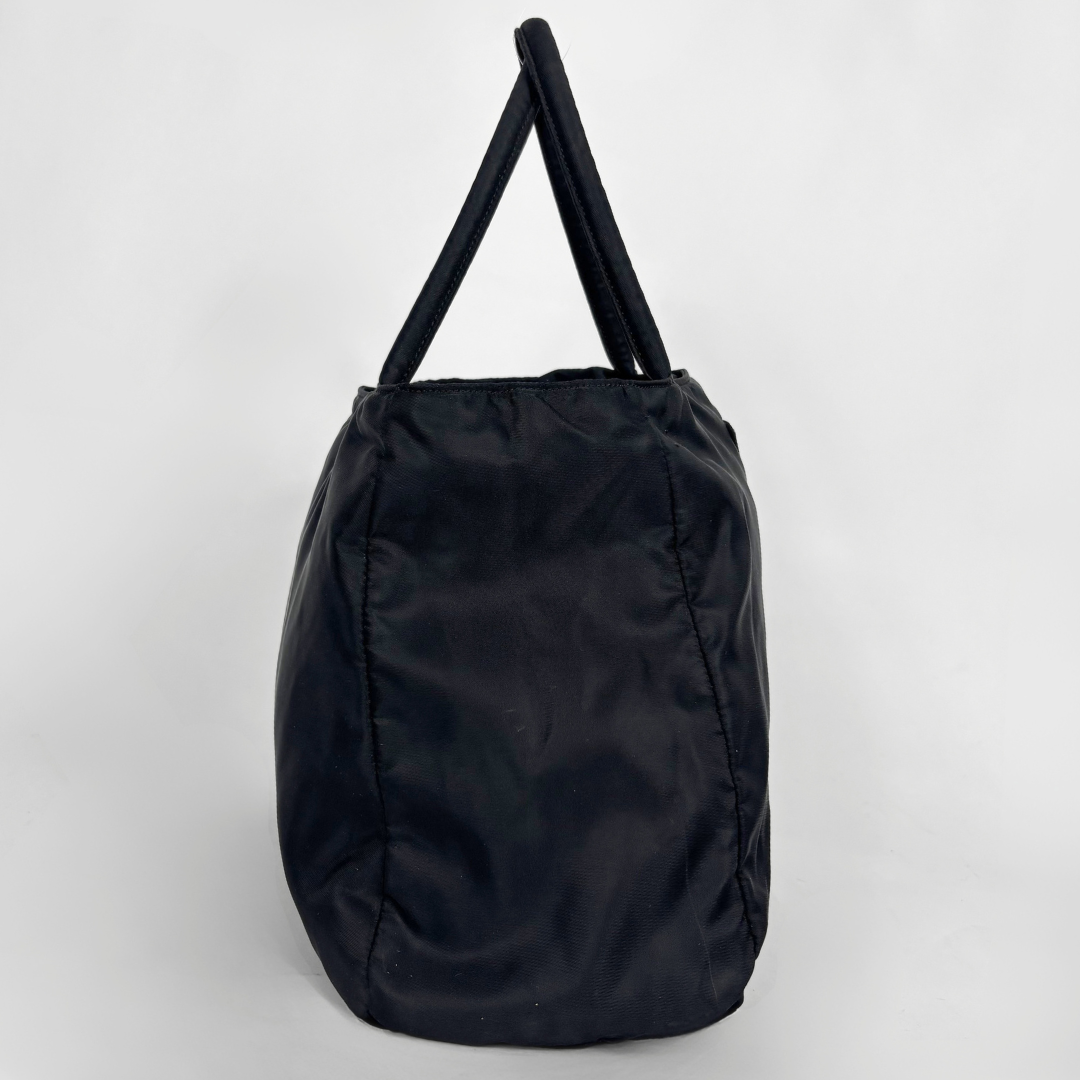 Prada black nylon tote bag with top handles and the classic enamel triangle logo.