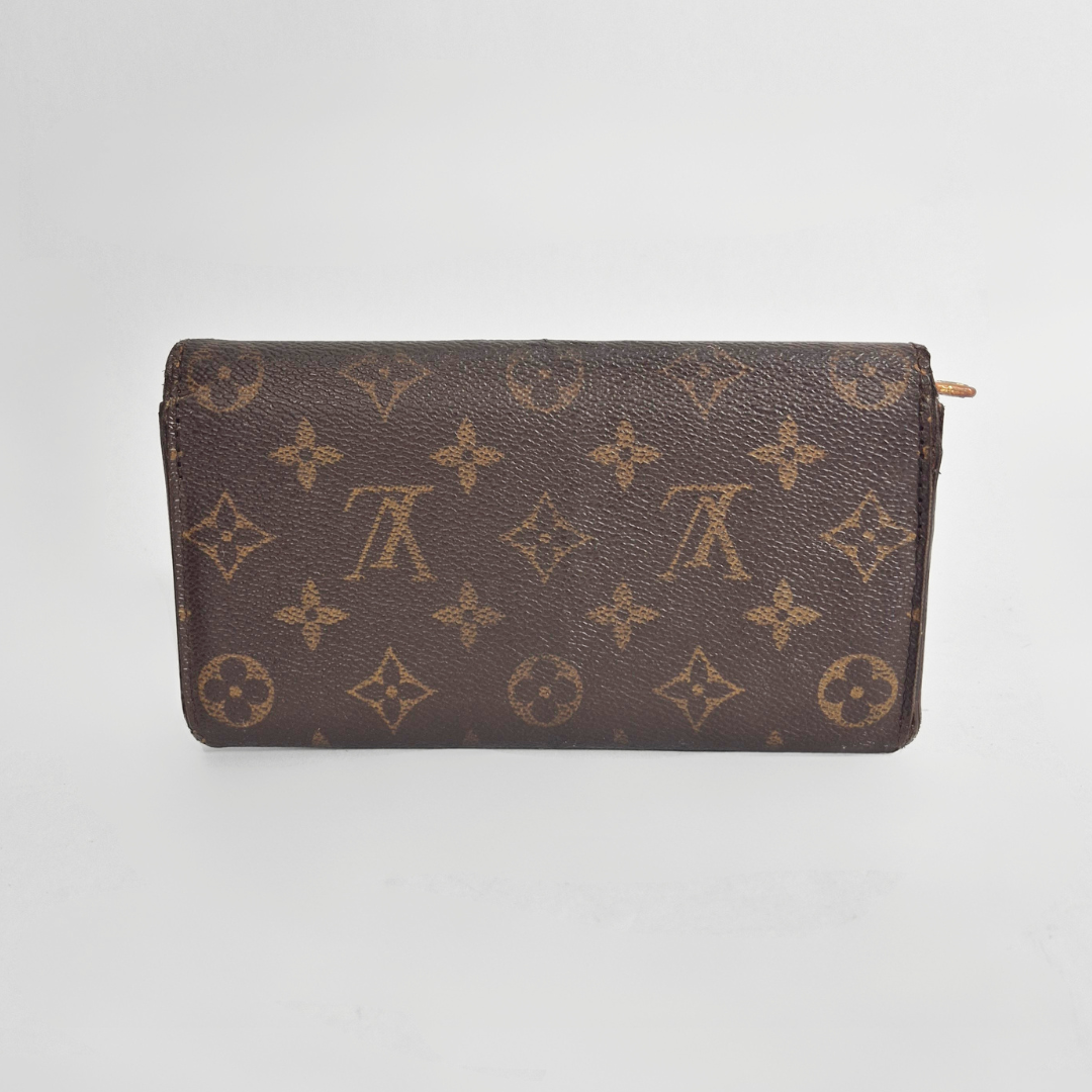 Brown wallet with monogram pattern on a white background
