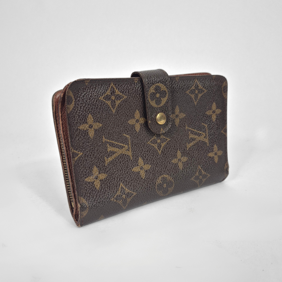 Louis Vuitton wallet with monogram pattern on a white background