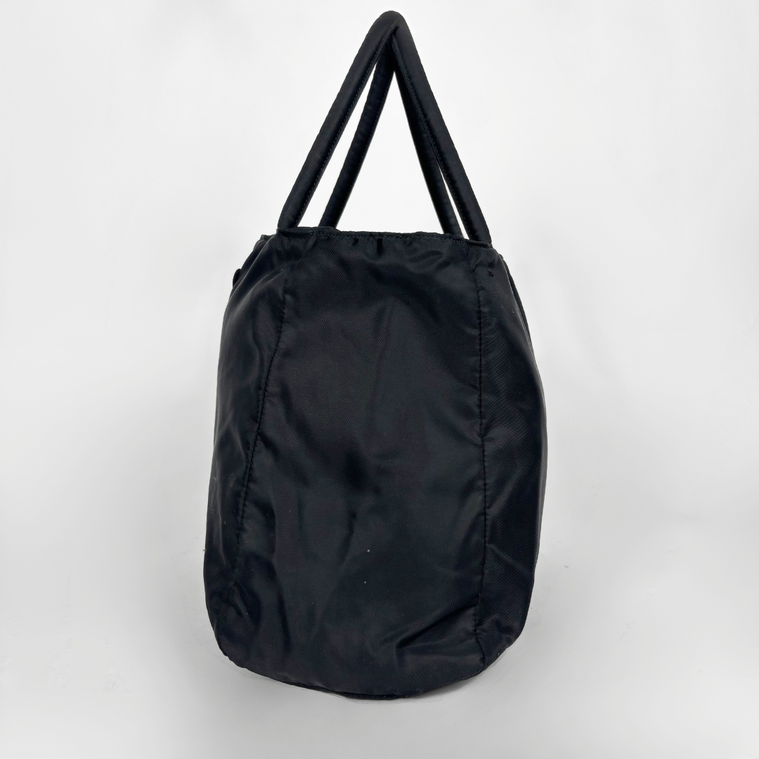 Prada black nylon tote bag with top handles and the classic enamel triangle logo.