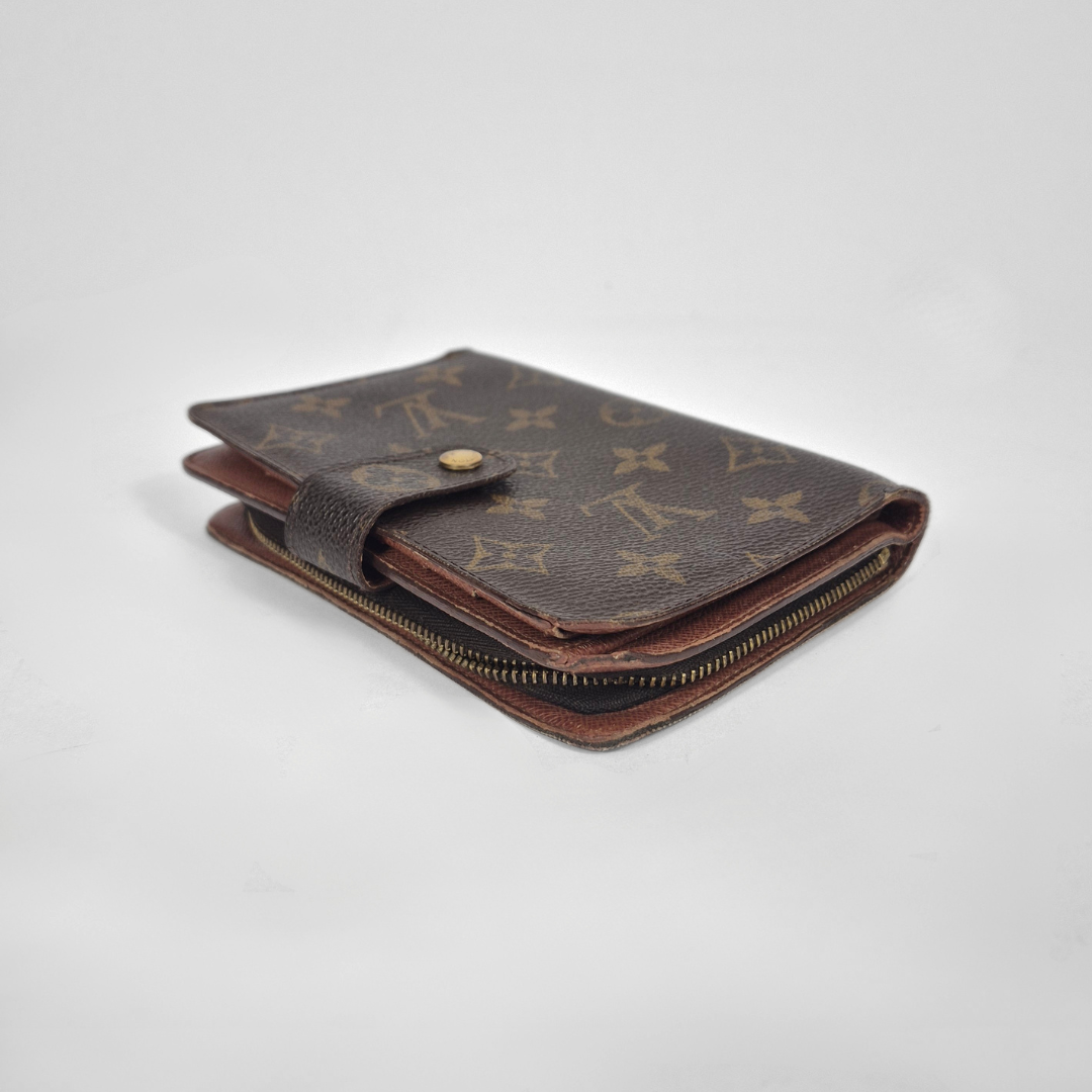 Louis Vuitton wallet with monogram pattern on a white background