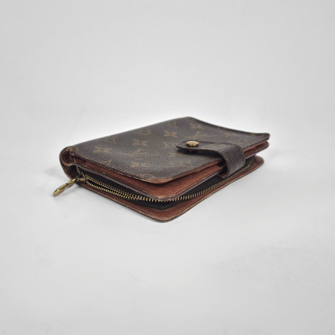 Louis Vuitton wallet with monogram pattern on a white background