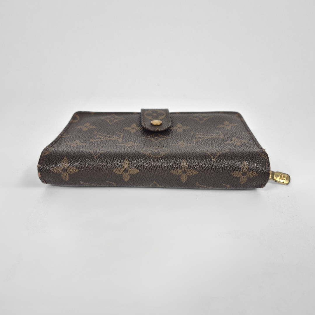 Louis Vuitton wallet with monogram pattern on a white background