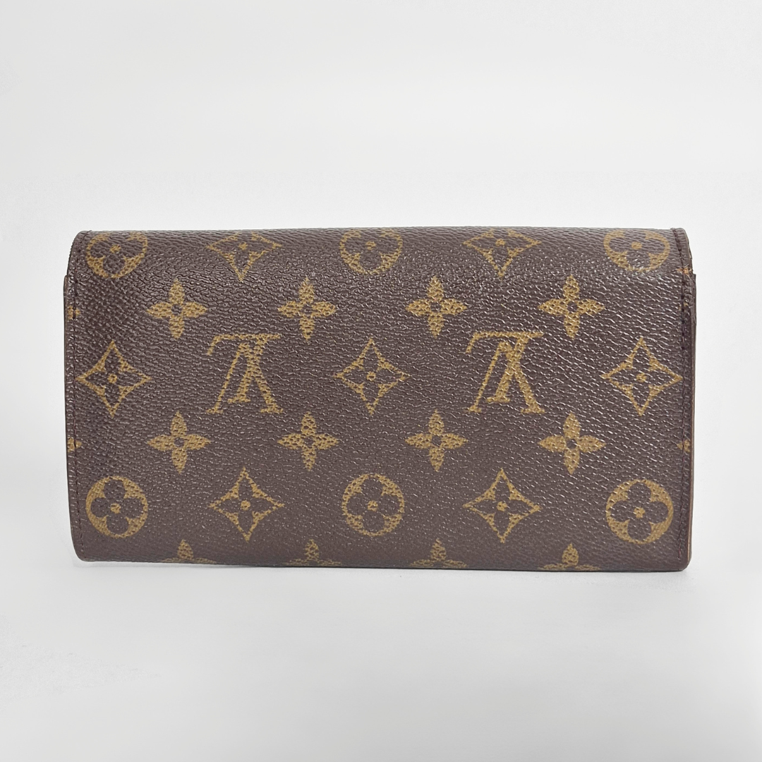 Brown wallet with gold monogram pattern on a light gray background