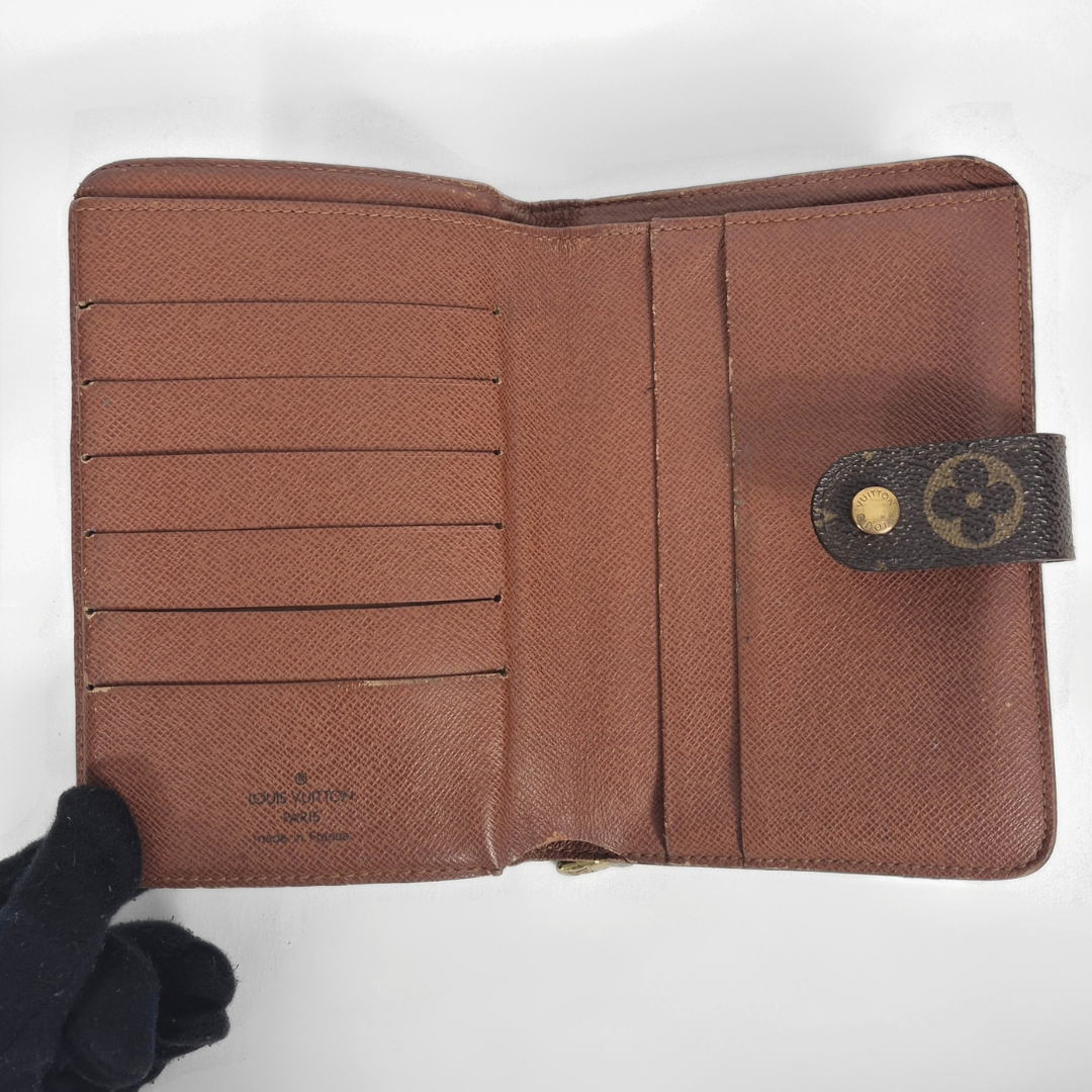 Louis Vuitton wallet with monogram pattern on a white background