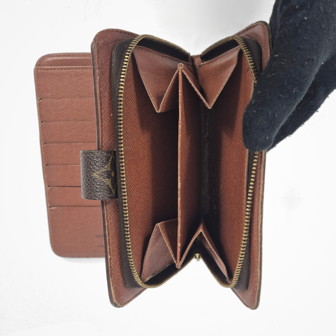 Louis Vuitton wallet with monogram pattern on a white background
