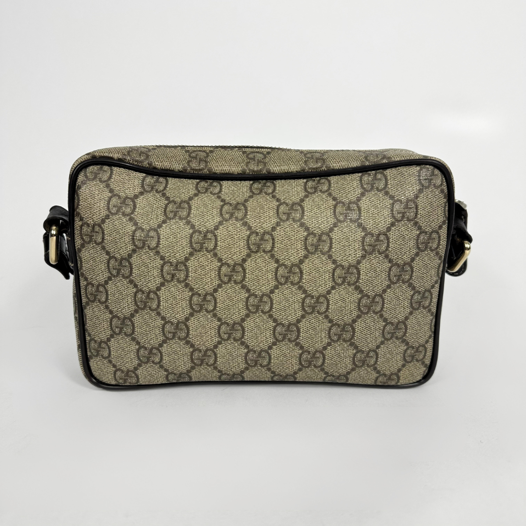 Gucci handbag with monogram pattern on a light gray background
