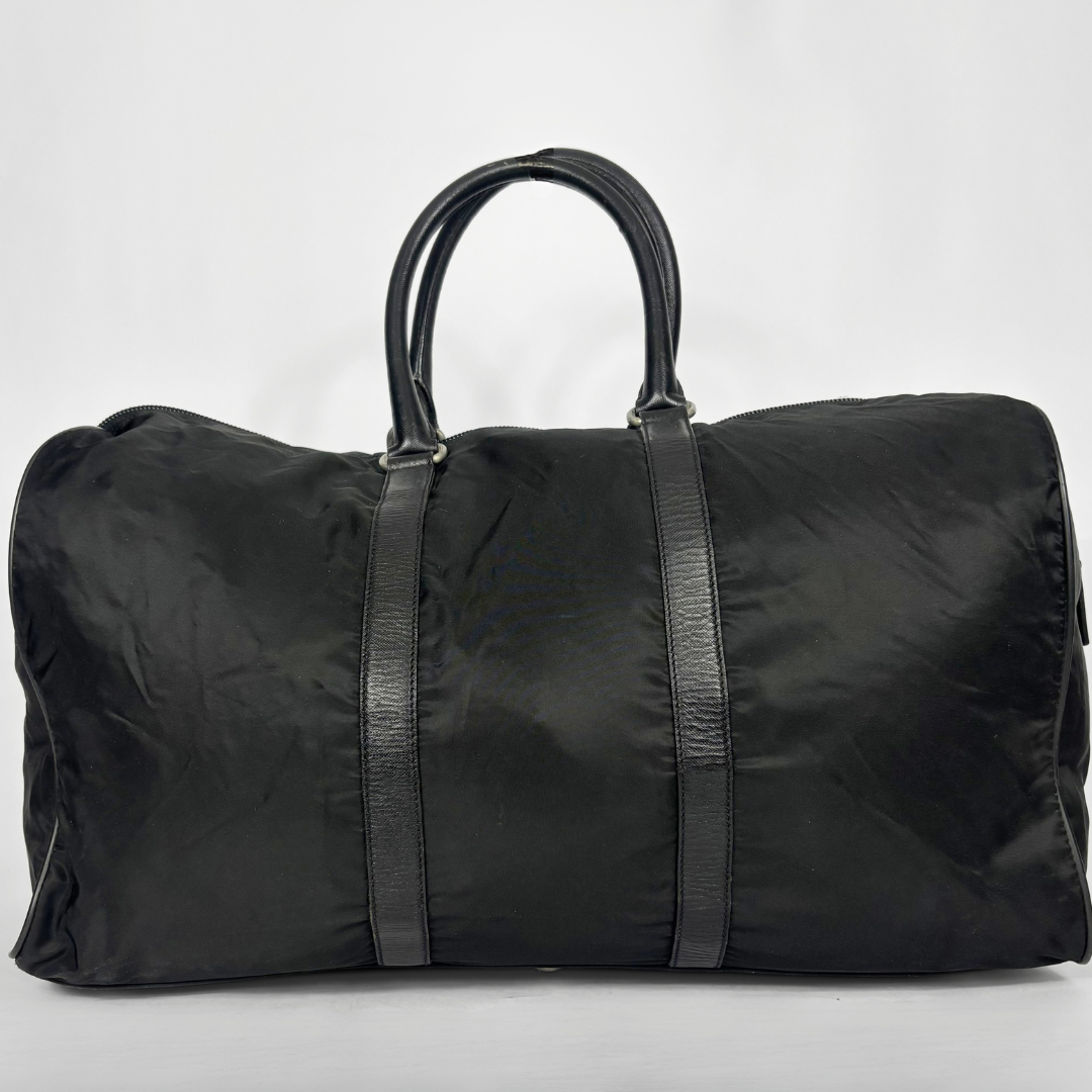 Black backpack with a strap and lock on a white background