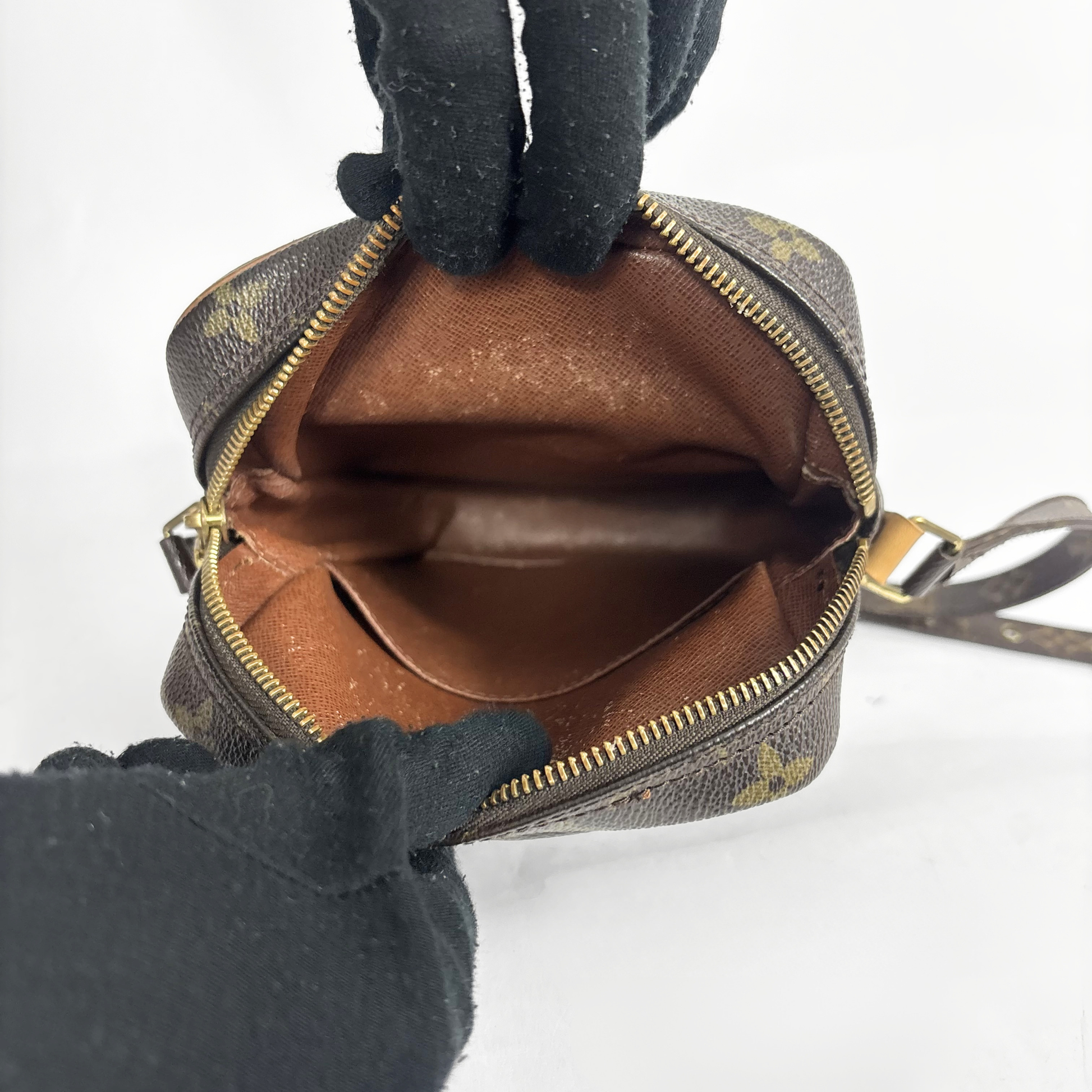 Brown leather bag with monogram pattern on a white background