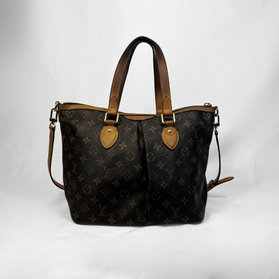 A Louis Vuitton monogram canvas tote bag with brown leather handles and trim, photographed against a white studio background.