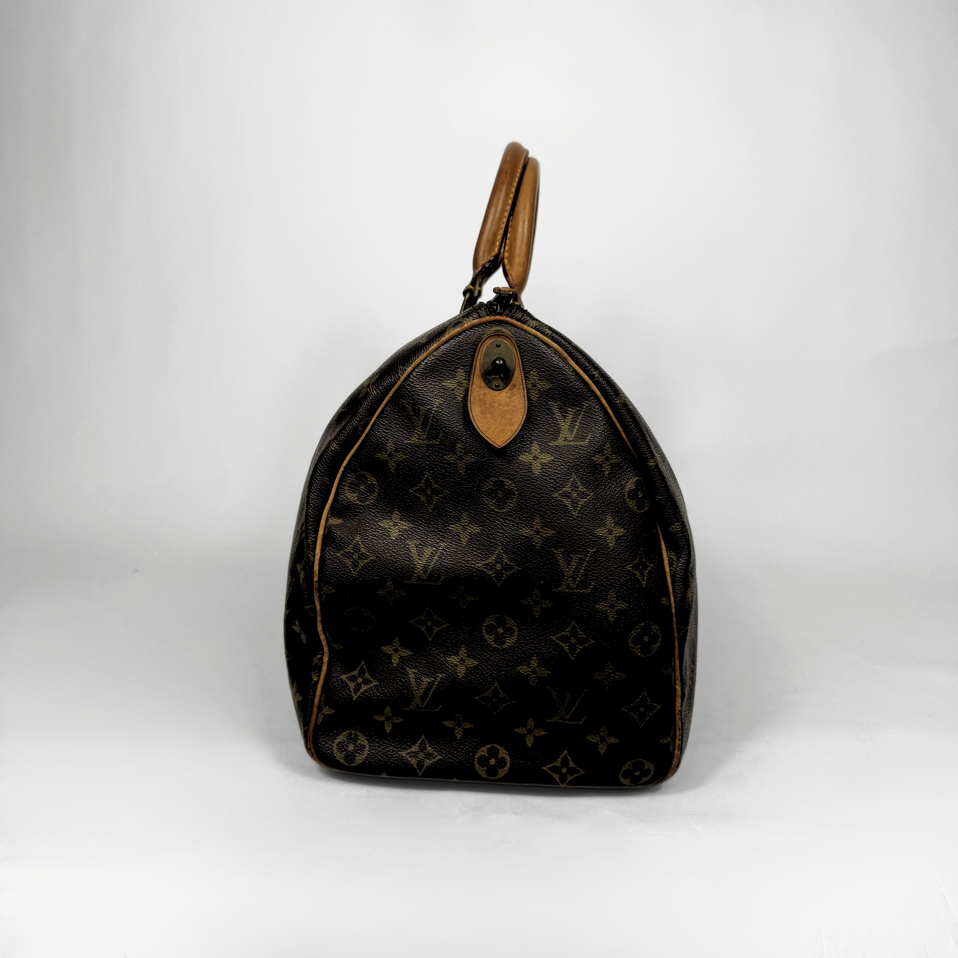 Designer handbag with monogram pattern on a white background