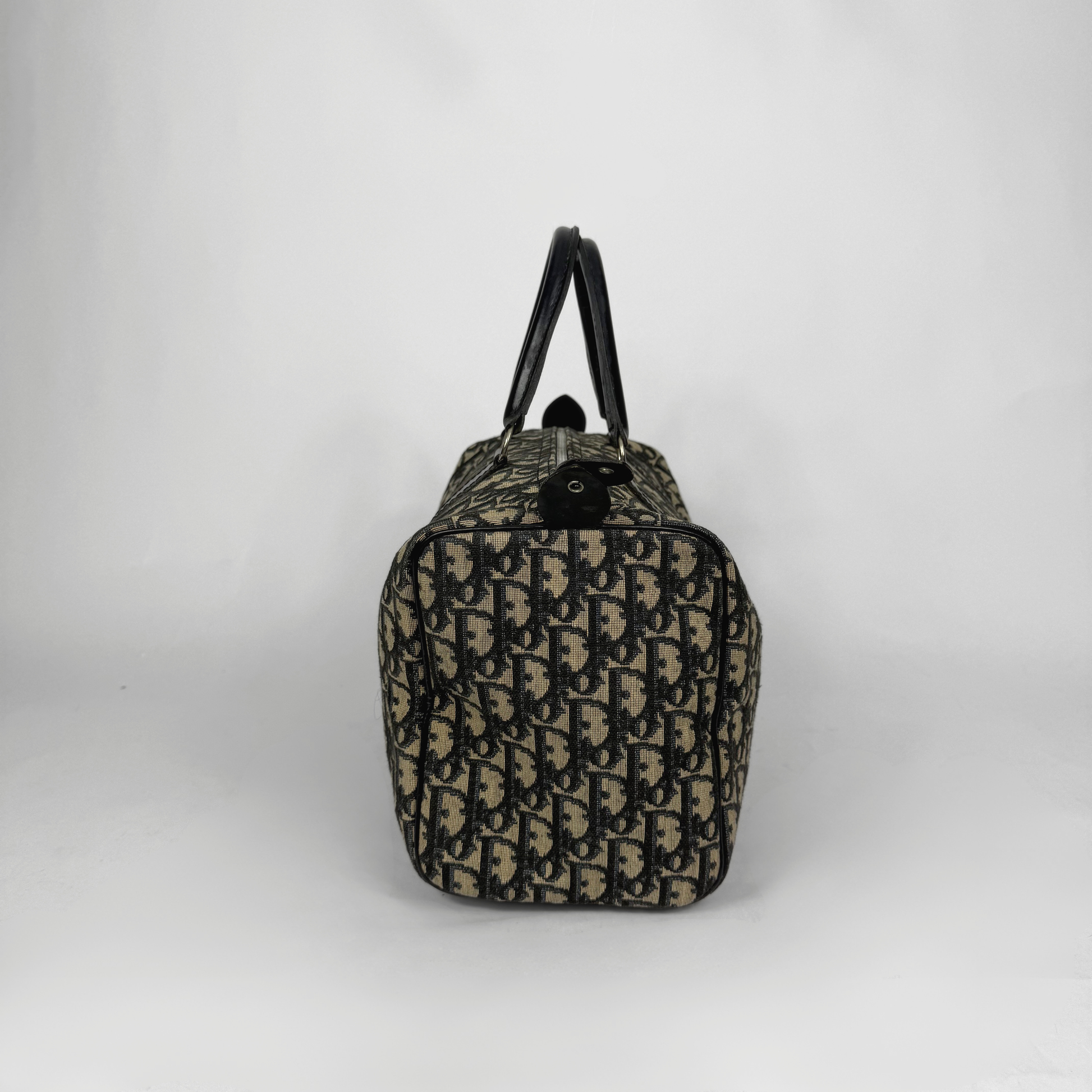 Designer handbag with monogram pattern on a white background