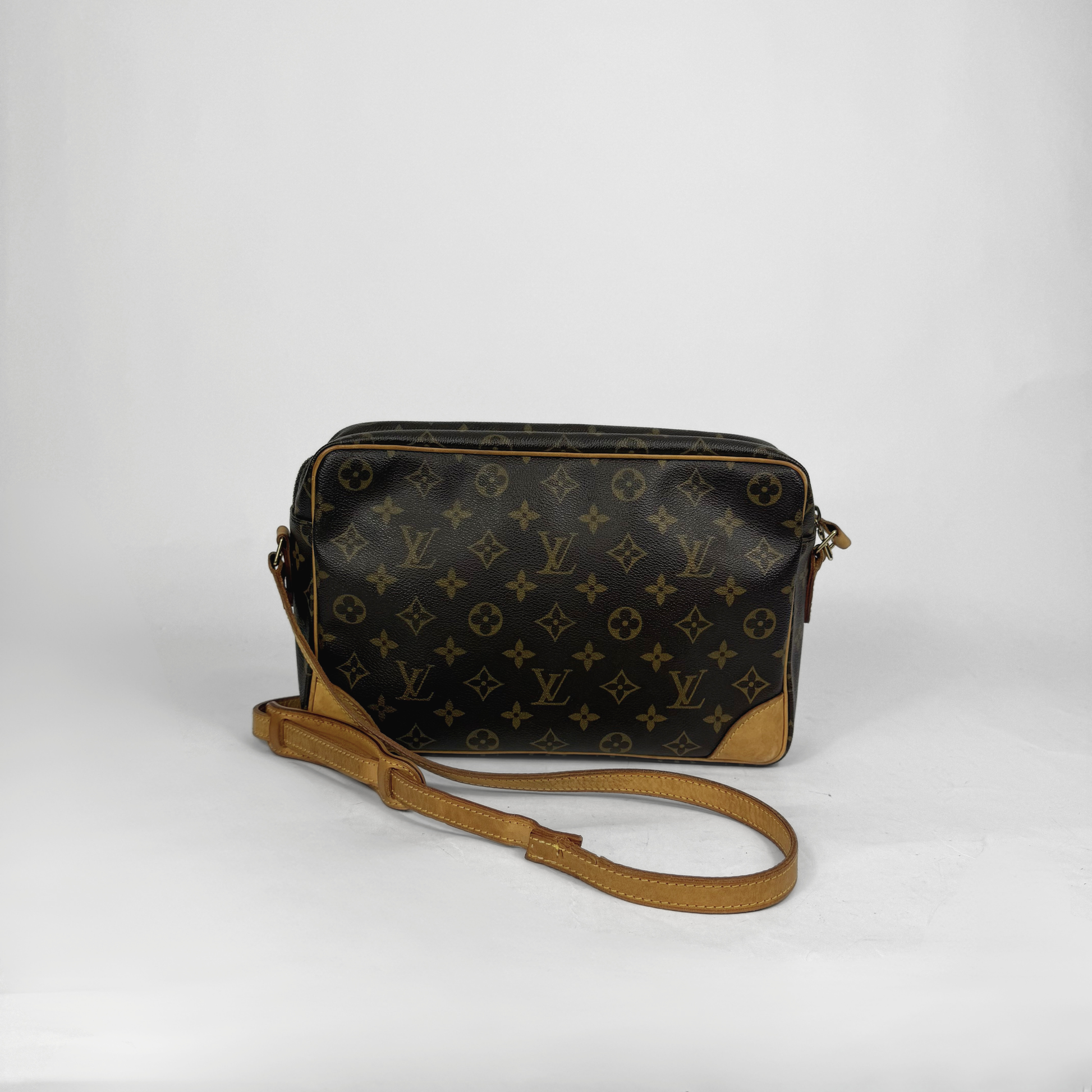 Designer handbag with monogram pattern on a white background