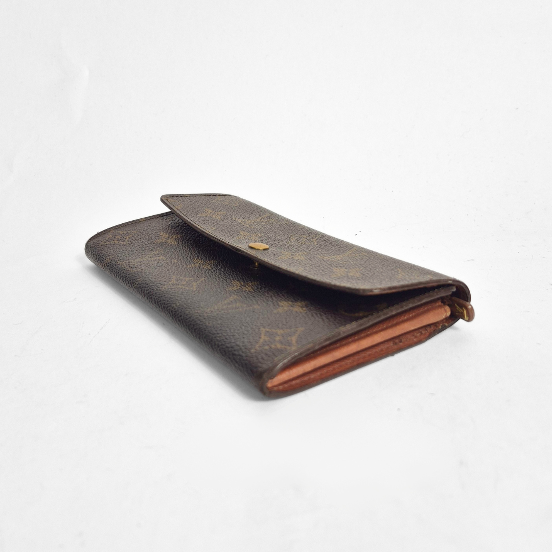 Brown wallet with monogram pattern on a white background