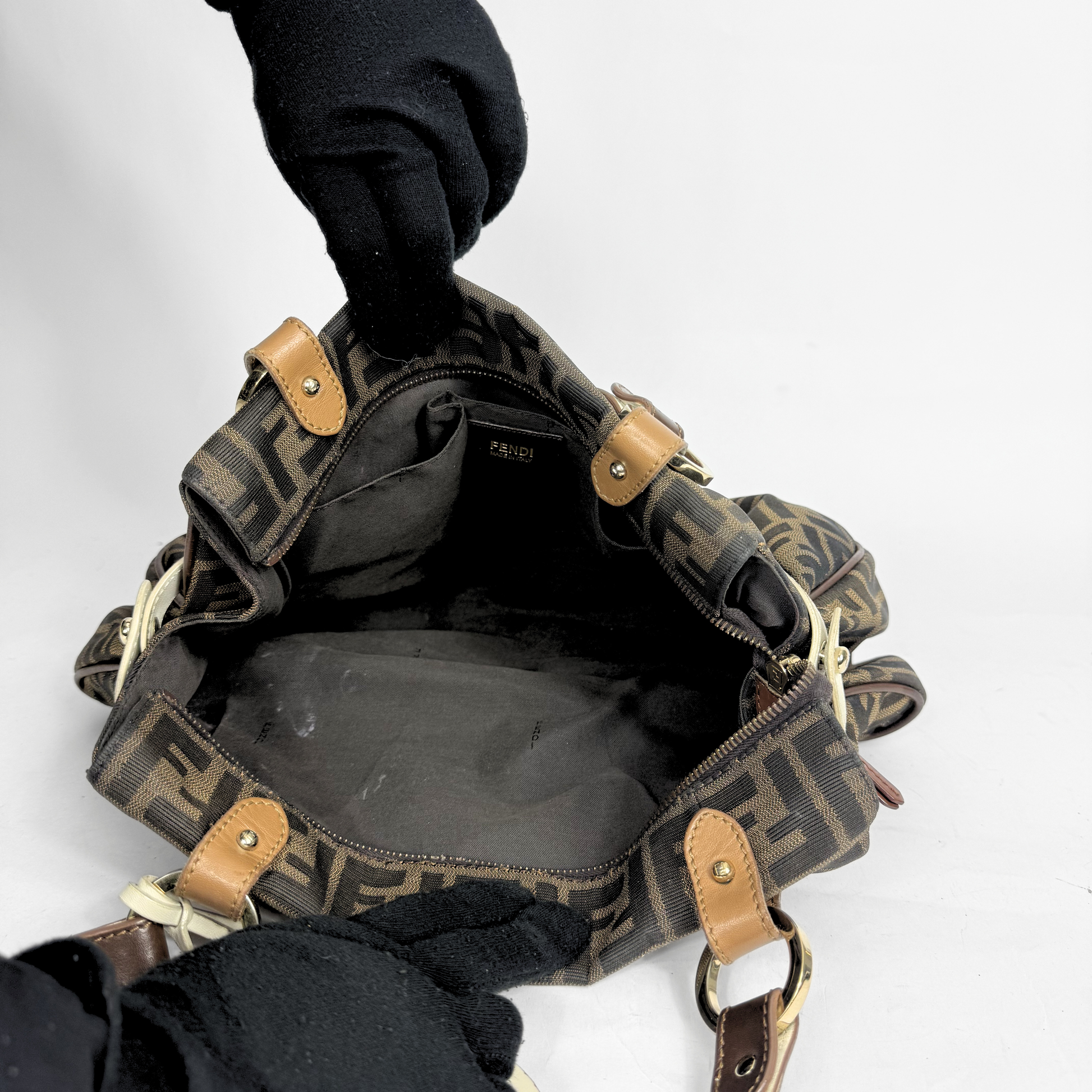 Fendi Zucca monogram canvas shoulder bag with letaher trim and a large white cicular FENDI charm: INSIDES.