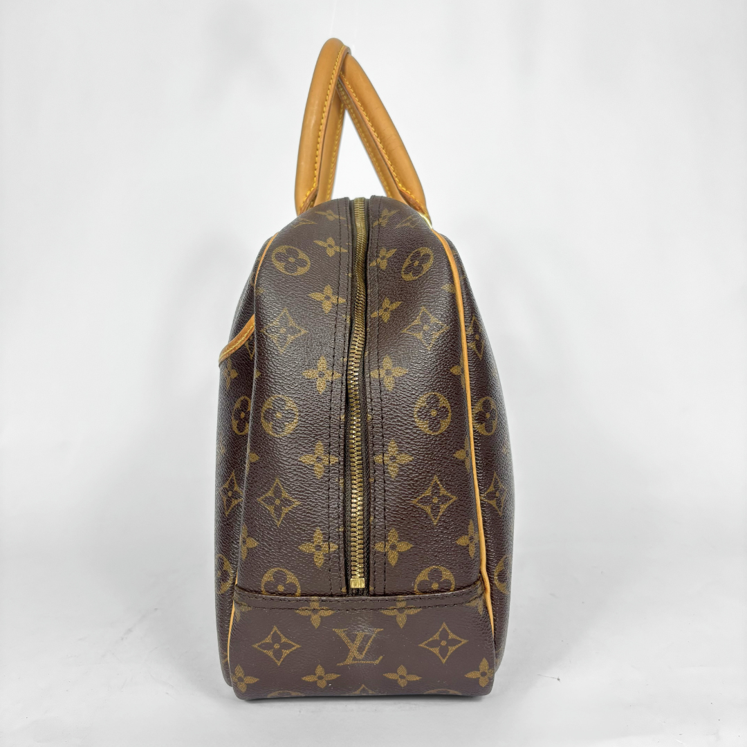 Designer handbag with monogram pattern on a white background