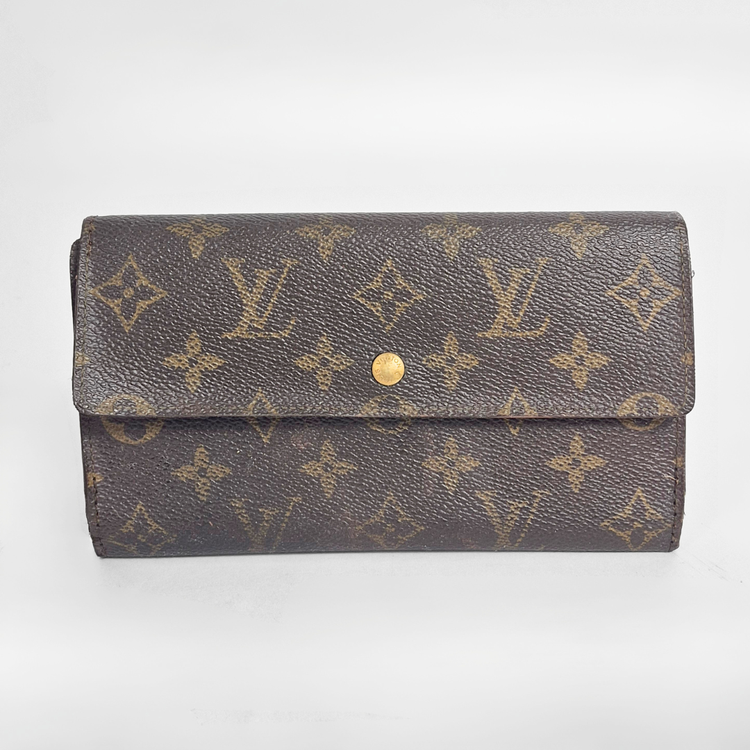 Louis Vuitton wallet with monogram pattern on a white background