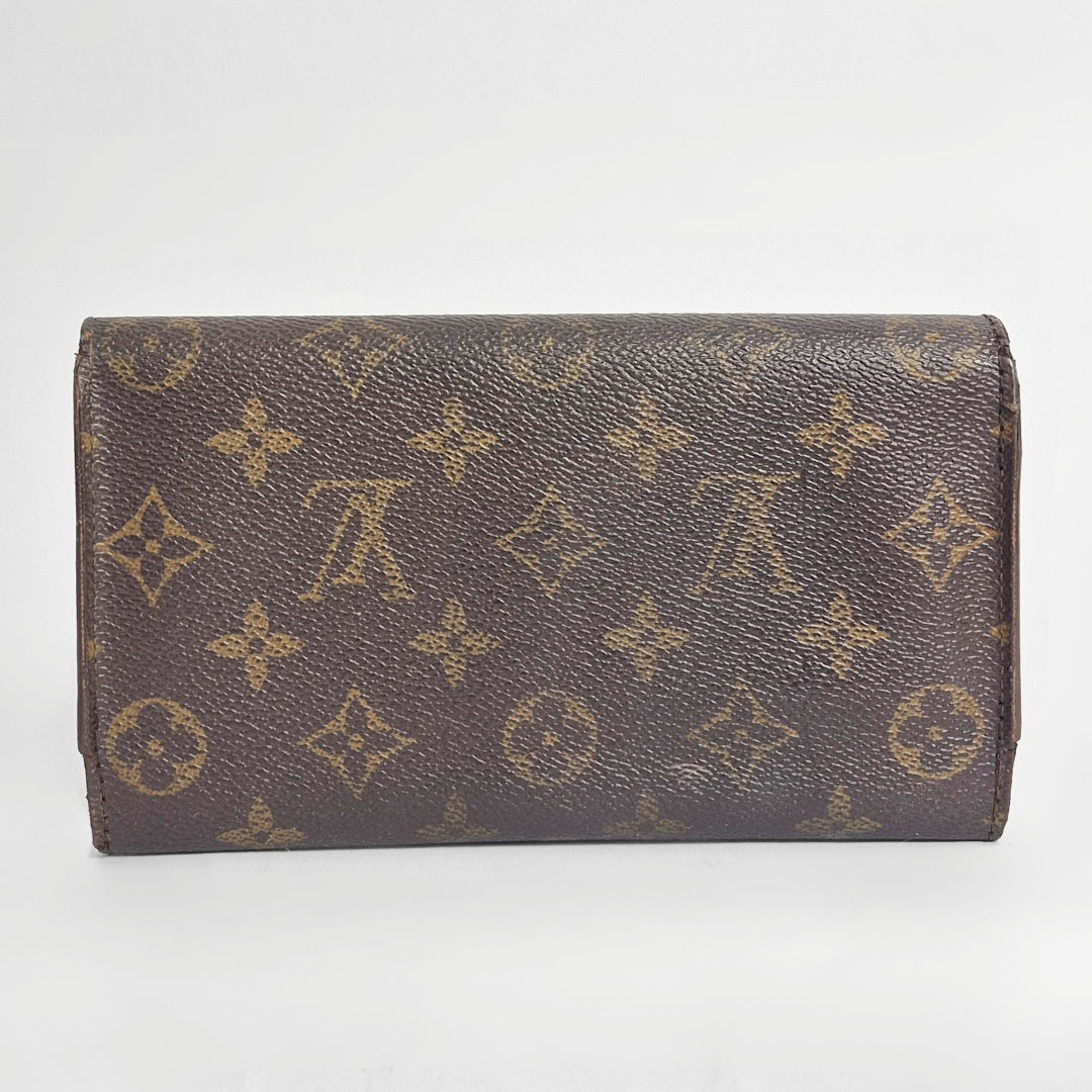 Brown wallet with monogram pattern on a white background