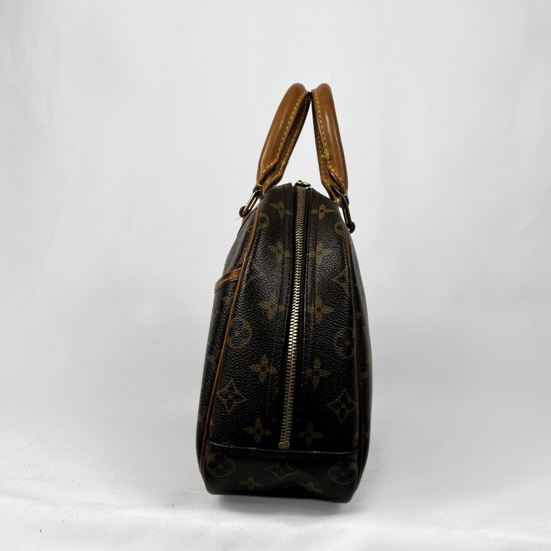 A Louis Vuitton monogram canvas handbag shown from the side against a white studio background.